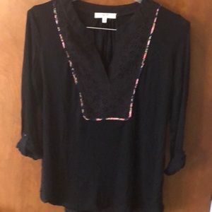 Black top with blue floral trim yoke